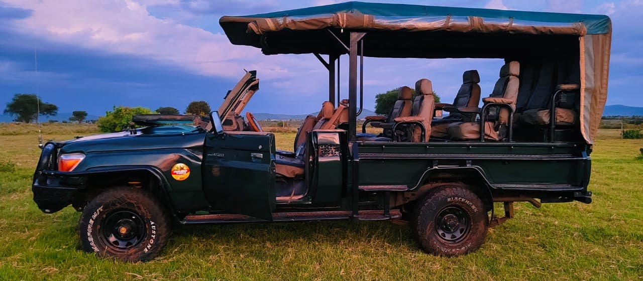 Open-sided Land Cruiser in the Masai Mara savannah
