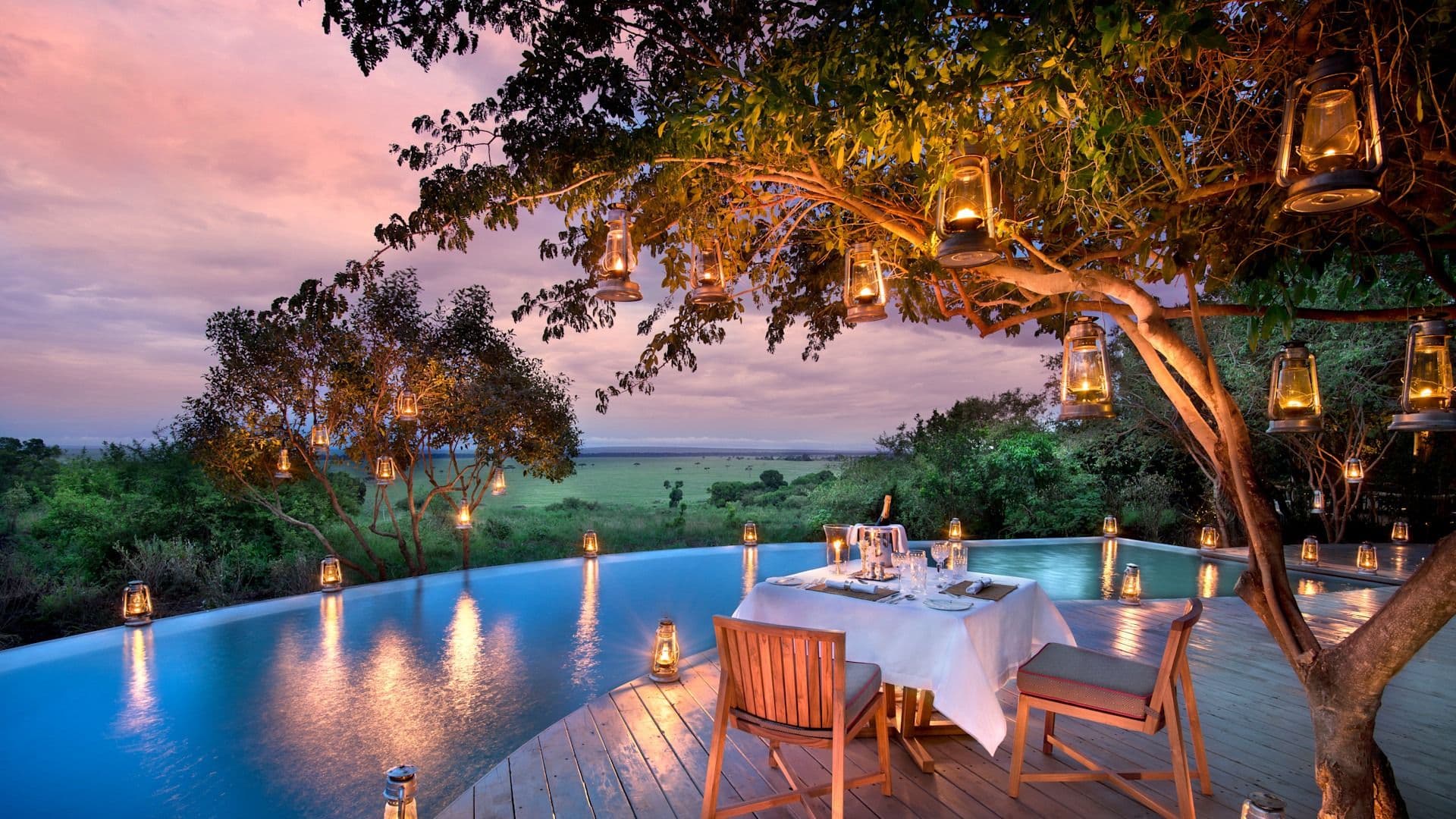 Romantic candlelit dinner on a luxury safari camp deck overlooking the Masai Mara